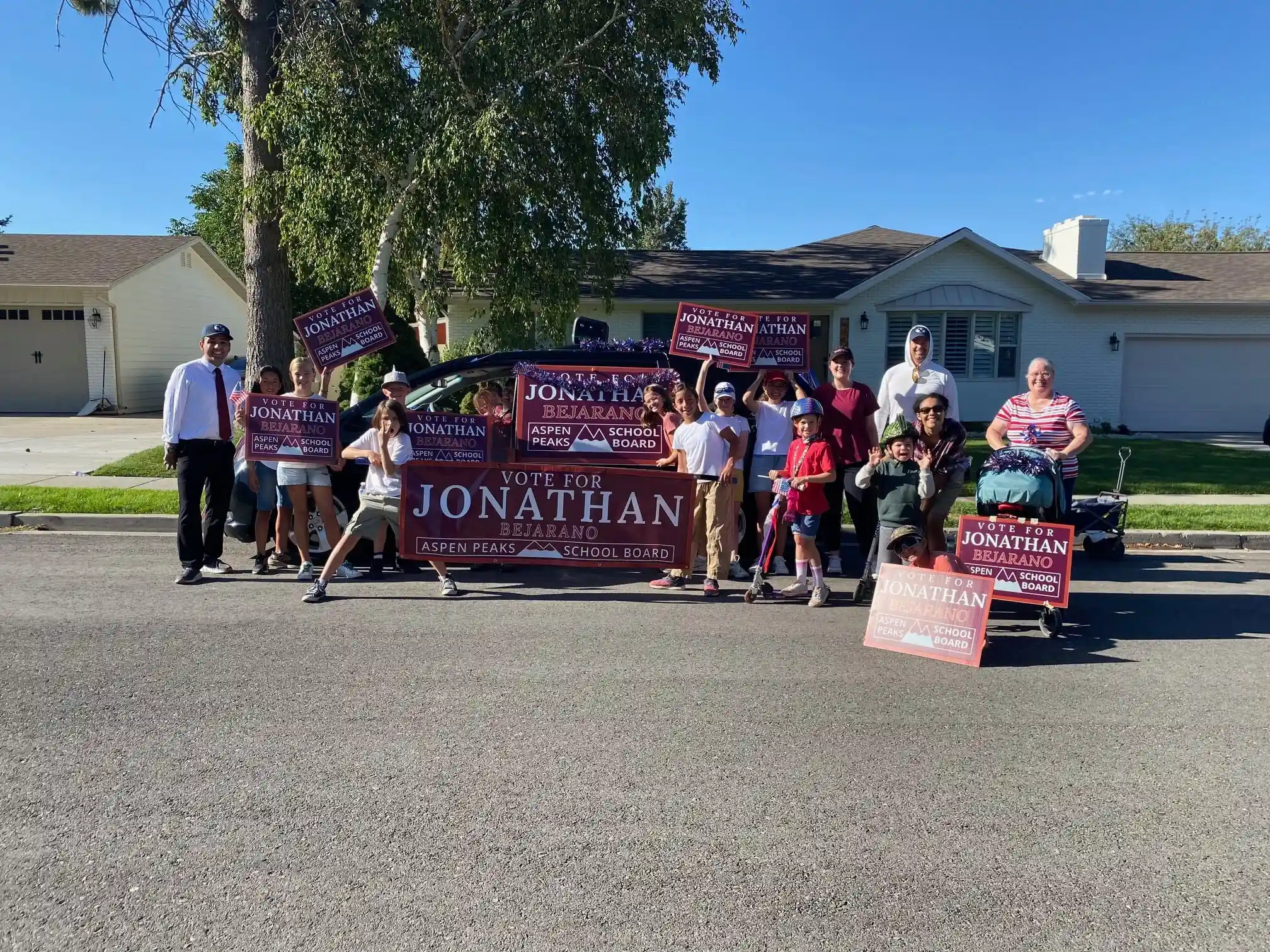 Community supporters at the Highland Fling Parade holding campaign signs